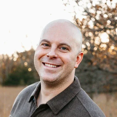 Chiropractor Ian McCann smiling outside.